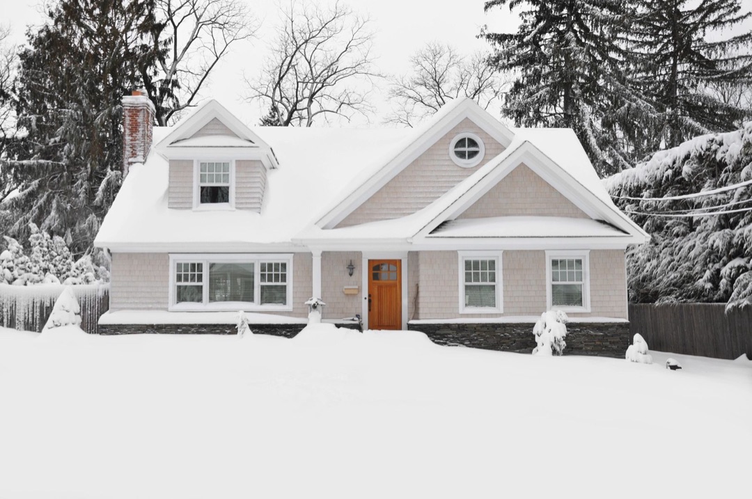 Snow-covered single-story house in winter